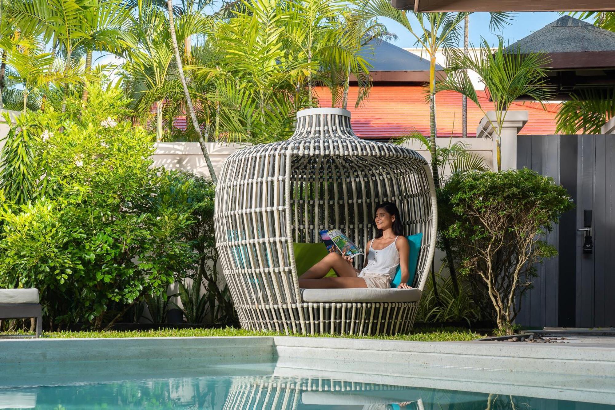 Dewa Phuket Resort & Villas Nai Yang Beach Exterior foto A woman relaxing in a pod at the pool